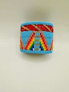 Sky blue and rainbow seed beads. It is 2.5 inches wide and is adjustable to fit any size wrist. It is lined with smoked hide. Made by the owner. Unique Multicolor Cuff Bracelet For Festival, Unique Colorful Beaded Cuff Bracelet For Festivals, Handmade Blue Cuff Bracelet, Unique Festival Cuff Bracelet With Colorful Beads, Adjustable Multicolor Cuff Bracelet, Adjustable Multicolor Unique Cuff Bracelet, Artisan Blue Cuff Bracelet, Adjustable Southwestern Blue Cuff Bracelet, Blue Cuff Bracelets For Festivals