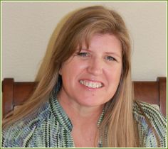 a woman with long blonde hair is smiling for the camera while wearing a green and white shirt