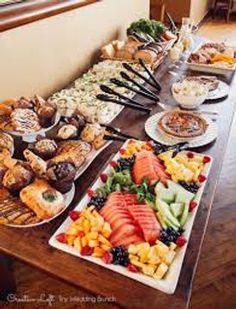 a long table filled with lots of different types of food on top of wooden tables