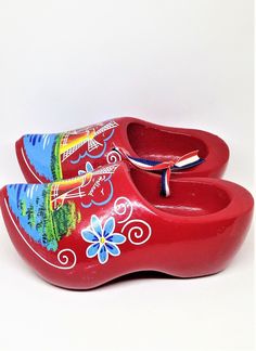 "Vintage Holland Shoes, Souvenir Shoes, Dutch Clogs, Red Holland Shoes, Floral Windmill, Holland Shoes, Klompenfabriek, Wooden Shoes Perfect collectible from Holland. Display piece. Very Colorful Dutch souvenir. Red Holland Clogs. Hang on the wall and fill with florals or greenery sprigs! Measures: 6\" long x 3\" wide each. Condition: Very good, Marked \"Holland\" near windmill. Please visit our shop to view our entire vintage selection at DartmouthHill: https://www.etsy.com/shop/DartmouthHill?r Dutch Shoes, Dutch Clogs, Red Clogs, Costume Shoes, Wooden Shoes, Clogs Shoes, Holland, Clogs, Sandals