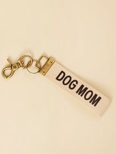 a keychain with the word dog mom printed on it