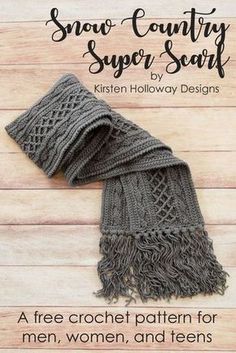 the snow country super scarf is knitted in grey yarn and sits on a wooden surface