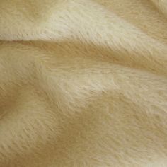 a close up view of a white fur textured material