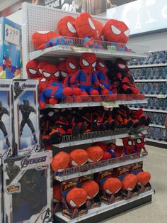 spider - man plush toys are on display in a store