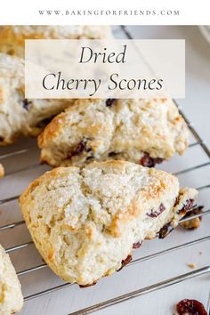 some scones are cooling on a wire rack with cranberry sauce in the background