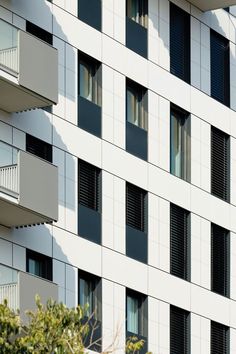 an apartment building with many windows and balconies