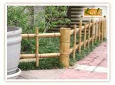 a bamboo fence that is next to a potted plant