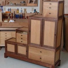 the cabinets are made from wood and have drawers on each side, with one door open