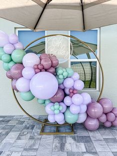 a balloon arch with pastel colors and balloons