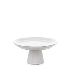 a white cake plate on a white background with no one around it to see the image