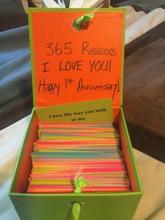 a green box filled with lots of cards and writing on the inside of it that says, 365 reason i love you happy 1st anniversary