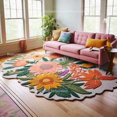 a living room with a pink couch and colorful rug on the floor in front of two windows