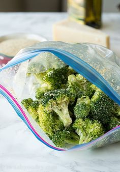 a bag filled with broccoli sitting on top of a counter