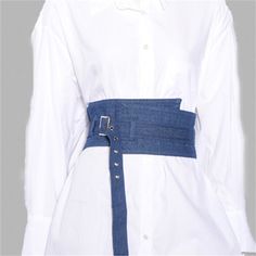 a woman wearing a white shirt and blue belt