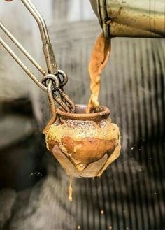 a person is pouring something into a pot