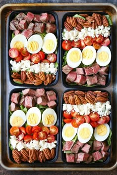 four trays filled with different types of food