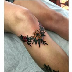 a woman's leg with flowers on it