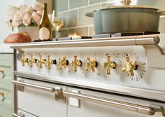 an old fashioned stove with brass knobs in a kitchen