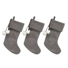 three christmas stockings with pom - poms hanging from them