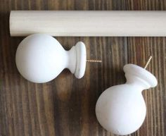 two white knobs on a wooden surface