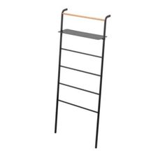 a black metal ladder with two shelves on each side