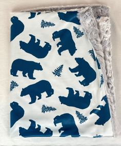 a blue and white blanket with bears on it