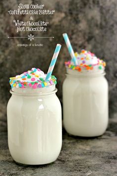 two mason jars filled with milk and topped with sprinkles