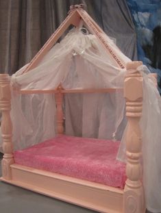 a pink bed with white netting on it