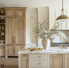 a large kitchen with marble counter tops and wooden cabinetry, along with an island in the middle