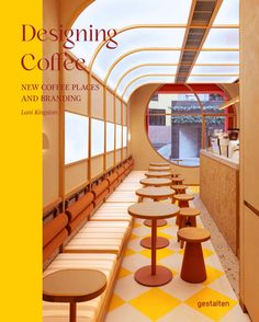 the cover of designing coffee new coffee places and breaking times, featuring tables in a cafe