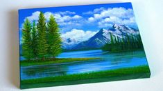 a painting of a lake with mountains in the background and trees on the other side