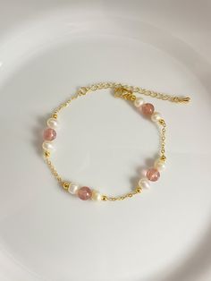 This charming bracelet is handmade with white freshwater pearls, pink strawberry crystal beads and a sturdy cable chain. The combination of pearls and crystals creates a stunning piece that adds a touch of elegance to any outfit. Freshwater pearl size is 5mm Strawberry crystal bead size is 5.8-6.2mm Bracelet length is 17+5cm As it's a handmade item please allow 2-3mm difference. Please let me know if you would like a different chain or length. Please keep them away from chemicals such as perfume, hairspray ect. Better remove before shower and swim.   The product is made by care and love 💕 Charming Bracelet, Strawberry Crystal, Pearl Charm Bracelet, Diy Jewelry Unique, Beading Jewelery, Bracelet Wedding, Pink Strawberry, Freshwater Pearl Bracelet, Bridal Bracelet