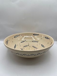 a white bowl with blue designs on it