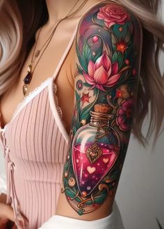 a woman with a tattoo on her arm and chest is wearing a pink top that has flowers in it