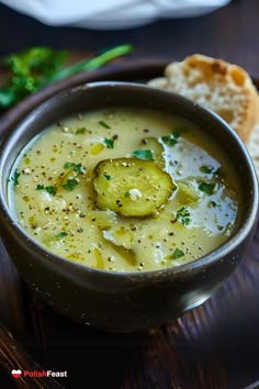 a bowl of soup on a plate with bread