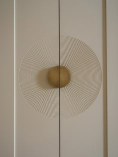 a white cabinet with a circular design on it