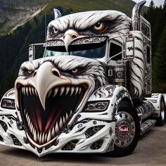 an eagle painted on the side of a semi - truck with mountains in the background