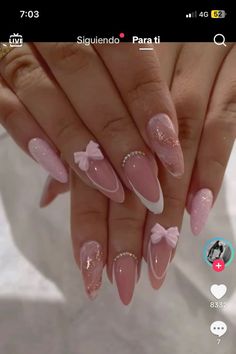 a woman's hand with pink and white nails on it, holding up her phone