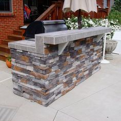 an outdoor bar made out of bricks and concrete