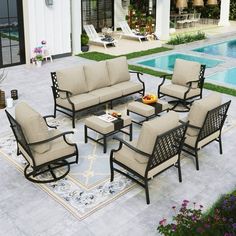 a patio furniture set sitting on top of a tile floor next to a swimming pool