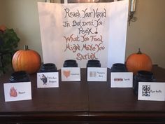 a table with pumpkins and cards on it