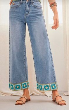 a woman is wearing high rise jeans with beading