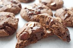 chocolate chip cookies with almonds on top and one broken in half