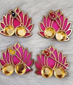 three pink and gold brooches sitting on top of a table