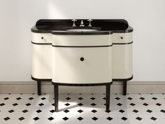 a bathroom sink sitting on top of a black and white counter