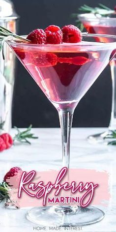 raspberry martini with rosemary garnish on the rim