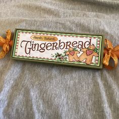 a gingerbread candy bar with an orange bow on it's end and the word gingerbread written in large letters