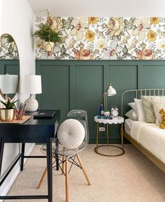 a bedroom with green paneled walls and floral wallpaper on the walls, along with a bed