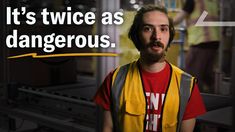 a man wearing a yellow vest and red shirt with the words it's twice as dangerous