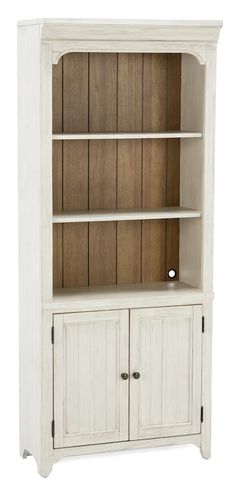 a white bookcase with wooden doors and drawers